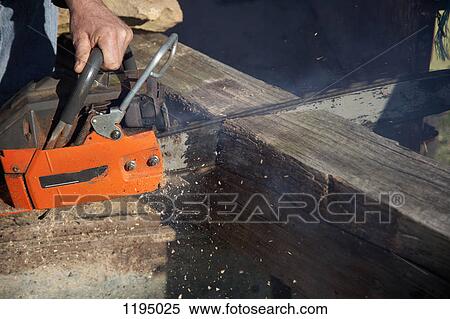 Detail of a man cutting wood with a chainsaw View Large Photo Image Stock Photography - Detail of a man cutting wood with a chainsaw. Fotosearch