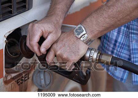 Detail of a man refueling View Large Photo Image Stock Photo - Detail of a man refueling. Fotosearch