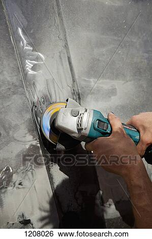 Detail of a man using an angle grinder View Large Photo Image Stock Photograph - Detail of a man using an angle grinder. Fotosearch