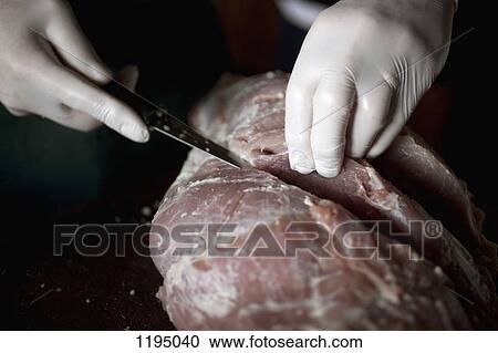 Detail of a person cutting raw meat View Large Photo Image Stock Image - Detail of a person cutting raw meat. Fotosearch