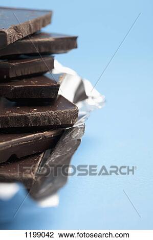 Detail of a stack of dark chocolate View Large Photo Image Stock Image - Detail of a stack of dark chocolate. Fotosearch