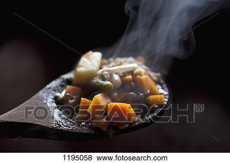 Detail of vegetable stew on a wooden spoon View Large Photo Image Stock Photo - Detail of vegetable stew on a wooden spoon. Fotosearch