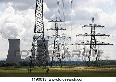 Stock Photo - Electricity pylons in front of a nuclear power station, Grafenrheinfeld, Germany. Fotosearch