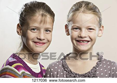 Fraternal twins smiling into the camera View Large Photo Image Stock Photograph - Fraternal twins smiling into the camera. Fotosearch