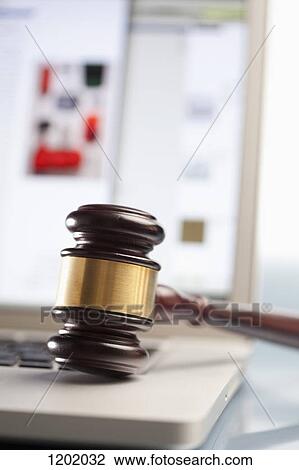 Stock Image - Gavel on laptop. Fotosearch