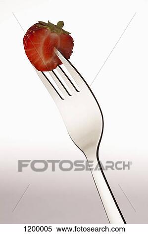 Half a strawberry on a fork View Large Photo Image Stock Photography - Half a strawberry on a fork. Fotosearch