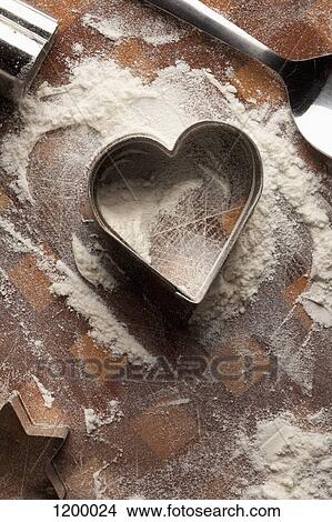 Heart shaped pastry cutter on floury table View Large Photo Image Picture - Heart shaped pastry cutter on floury table. Fotosearch