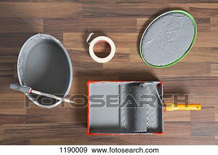 Stock Photo - House painting equipment on a hardwood floor. Fotosearch