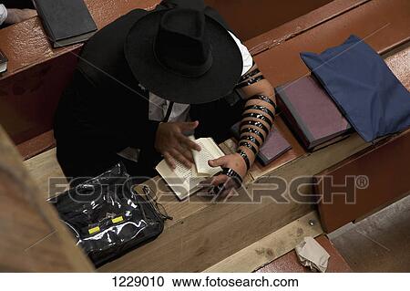 Jewish man with tefillin reading religious prayer book View Large Photo Image Stock Image - Jewish man with tefillin reading religious prayer book. Fotosearch