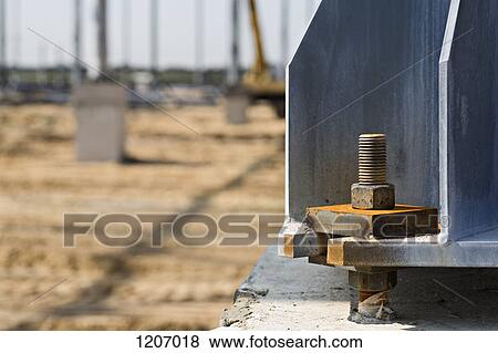 Stock Photo - Large nut and bolt connected to beam in construction site. Fotosearch