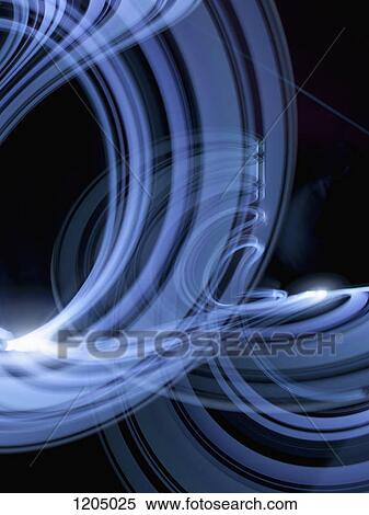 Stock Photography - Light trails creating an abstract blue swirling pattern on a black background. Fotosearch