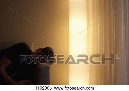 Man lying on couch beside glowing electric light View Large Photo Image Stock Photography - Man lying on couch beside glowing electric light. Fotosearch