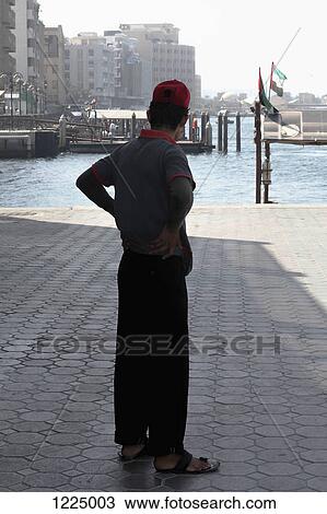 Man on pier at Dubai Creek, Dubai, United Arab Emirates View Large Photo Image Stock Image - Man on pier at Dubai Creek, Dubai, United Arab Emirates. Fotosearch