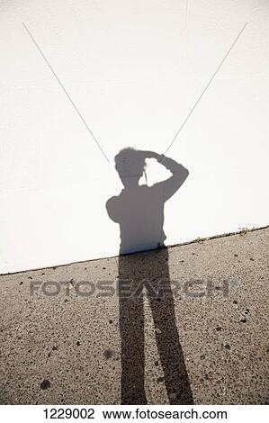 Photographer's shadow against ground and wall View Large Photo Image Stock Image - Photographer's shadow against ground and wall. Fotosearch