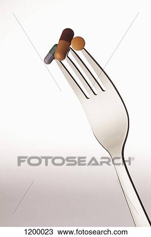 Pills on a fork View Large Photo Image Stock Image - Pills on a fork. Fotosearch