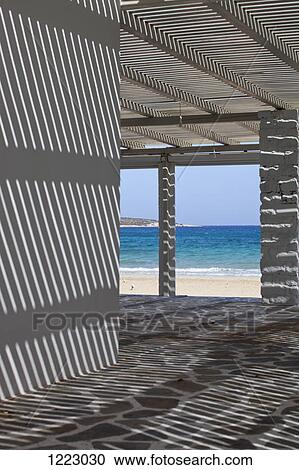Play of light and shadow in beach shelter View Large Photo Image Stock Image - Play of light and shadow in beach shelter. Fotosearch