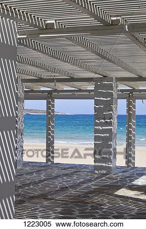 Play of light and shadow in beach shelter View Large Photo Image Stock Photography - Play of light and shadow in beach shelter. Fotosearch