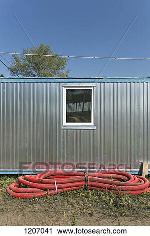 Red conduit tied up in front of industrial building View Large Photo Image Stock Image - Red conduit tied up in front of industrial building. Fotosearch