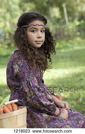 Retro styled girl beside basket of picked carrots View Large Photo Image Stock Image - Retro styled girl beside basket of picked carrots. Fotosearch
