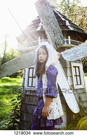 Picture - Retro styled girl beside small windmill,. Fotosearch