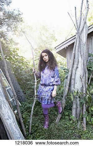 Retro styled girl by tree branches View Large Photo Image Stock Photograph - Retro styled girl by tree branches. Fotosearch