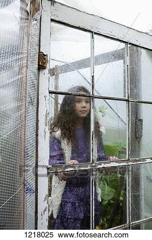 Stock Photography - Retro styled girl in old greenhouse. Fotosearch