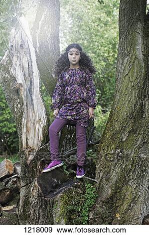 Retro styled girl standing on tree View Large Photo Image Stock Photo - Retro styled girl standing on tree. Fotosearch
