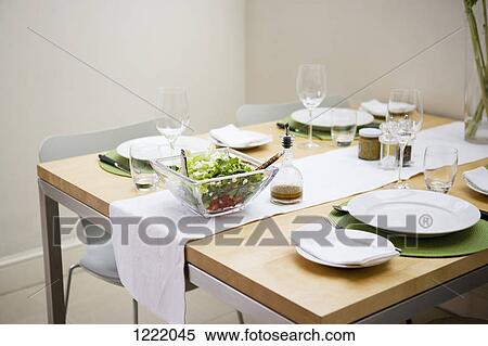 Stock Photography - Salad bowl on dining table. Fotosearch