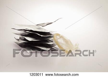 Several unopened condom wrappers in a stack and one opened one View Large Photo Image Stock Image - Several unopened condom wrappers in a stack and one opened one. Fotosearch