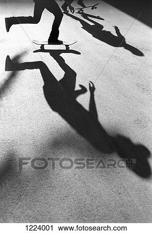 Silhouetted skateboarders View Large Photo Image Stock Image - Silhouetted skateboarders. Fotosearch