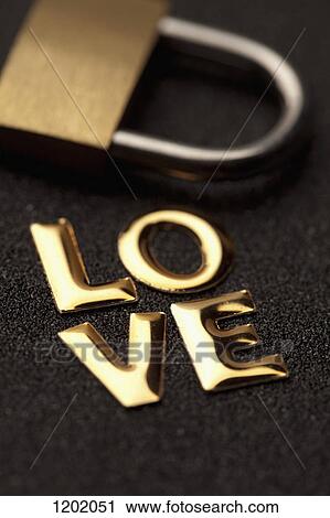 Single word 'love' in gold lettering beside padlock View Large Photo Image Stock Image - Single word 'love' in gold lettering beside padlock. Fotosearch