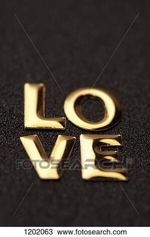Stock Image - Single word 'love' in gold lettering. Fotosearch