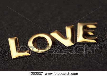 Stock Photo - Single word 'love' in gold lettering. Fotosearch