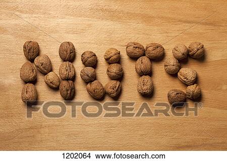 Picture - Single word 'nuts' spelled with walnuts. Fotosearch