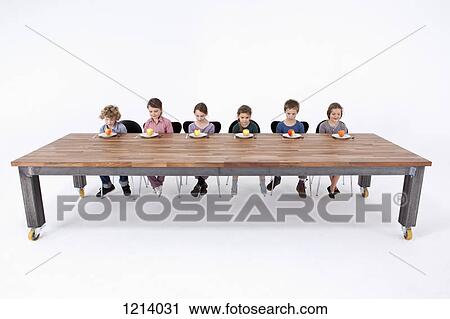Six kids looking down at apples on their plates with uncertainty View Large Photo Image Stock Image - Six kids looking down at apples on their plates with uncertainty. Fotosearch