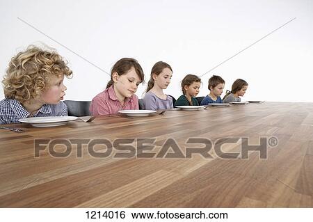 Six sad kids looking down longingly at their empty plates View Large Photo Image Stock Photograph - Six sad kids looking down longingly at their empty plates. Fotosearch