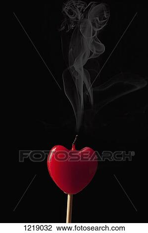 Smoke coming from an extinguished heart shaped candle on a stick View Large Photo Image Stock Image - Smoke coming from an extinguished heart shaped candle on a stick. Fotosearch