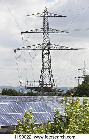 Solar panels in front of an electricity pylon View Large Photo Image Stock Image - Solar panels in front of an electricity pylon. Fotosearch