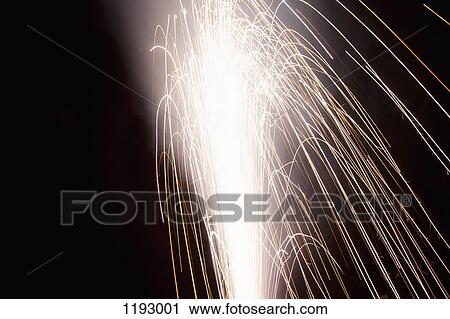 Stock Image - Sparks shooting from a firework. Fotosearch