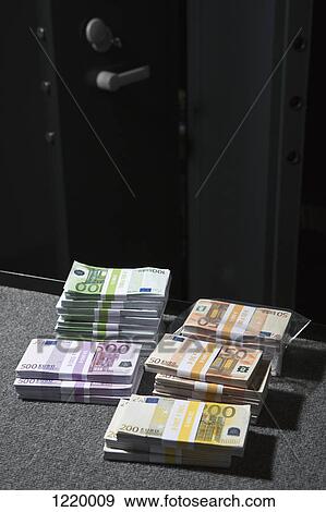 Stacks of large billed Euro banknotes on a table outside of a vault View Large Photo Image Stock Photo - Stacks of large billed Euro banknotes on a table outside of a vault. Fotosearch