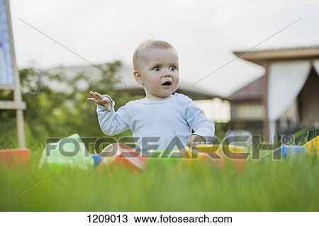 Surprised baby in the garden View Large Photo Image Stock Image - Surprised baby in the garden. Fotosearch