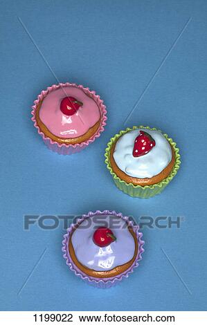 Stock Image - Three cupcakes. Fotosearch