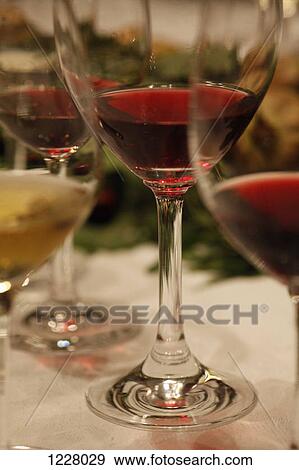 Three glasses of red wine and a glass of white wine at a wine tasting, close-up View Large Photo Image Stock Photo - Three glasses of red wine and a glass of white wine at a wine tasting, close-up. Fotosearch