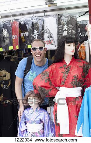 Tourist standing beside female mannequins wearing kimonos, View Large Photo Image Picture - Tourist standing beside female mannequins wearing kimonos, . Fotosearch