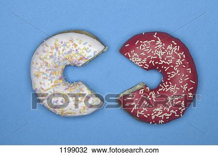 Two donuts with missing pieces View Large Photo Image Stock Image - Two donuts with missing pieces. Fotosearch