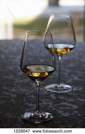Two glasses of white wine at a wine tasting View Large Photo Image Stock Photo - Two glasses of white wine at a wine tasting. Fotosearch