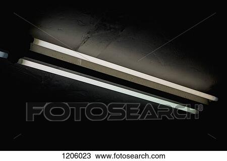 Stock Image - Two tube lights surrounded by darkness. Fotosearch