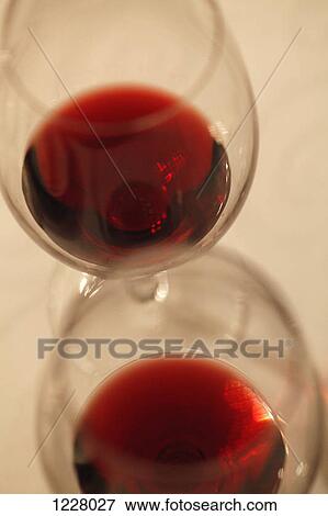 Stock Photo - Two wineglasses with red wine in them at a wine tasting. Fotosearch