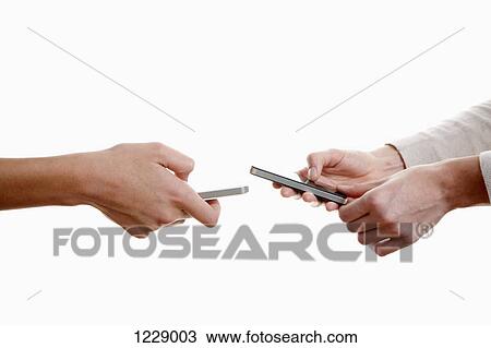 Two women using their phones View Large Photo Image Stock Image - Two women using their phones. Fotosearch