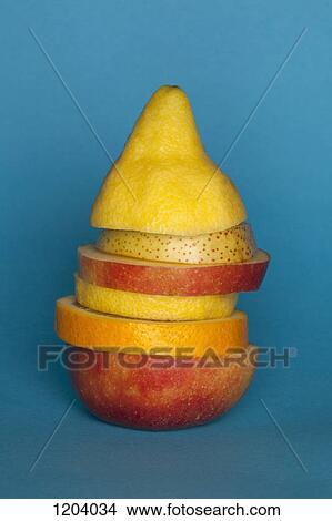 Picture - Uneven slices of different fruit stacked to comprise the shape of a piece of fruit. Fotosearch